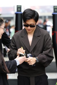 SHANGHAI, CHINA - APRIL 21: Zhou Guanyu of China and Stake F1 Team Kick Sauber greets fans in the Paddock prior to the F1 Grand Prix of China at Shanghai International Circuit on April 21, 2024 in Shanghai, China. (Photo by Lintao Zhang/Getty Images )