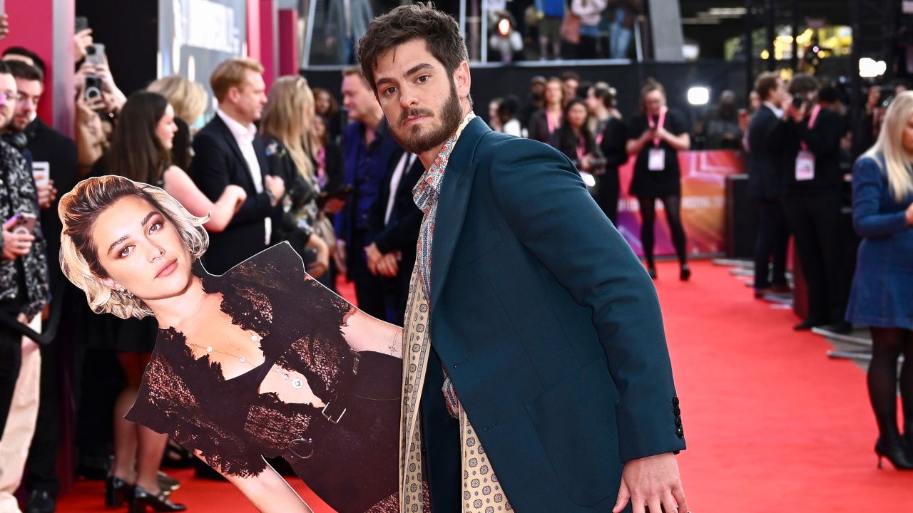 Andrew Garfield poses with a cardboard cutout of Florence Pugh at the 