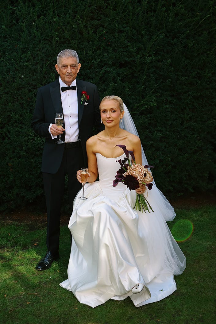 bride amy shaw and her father having a glass of champagne before her wedding