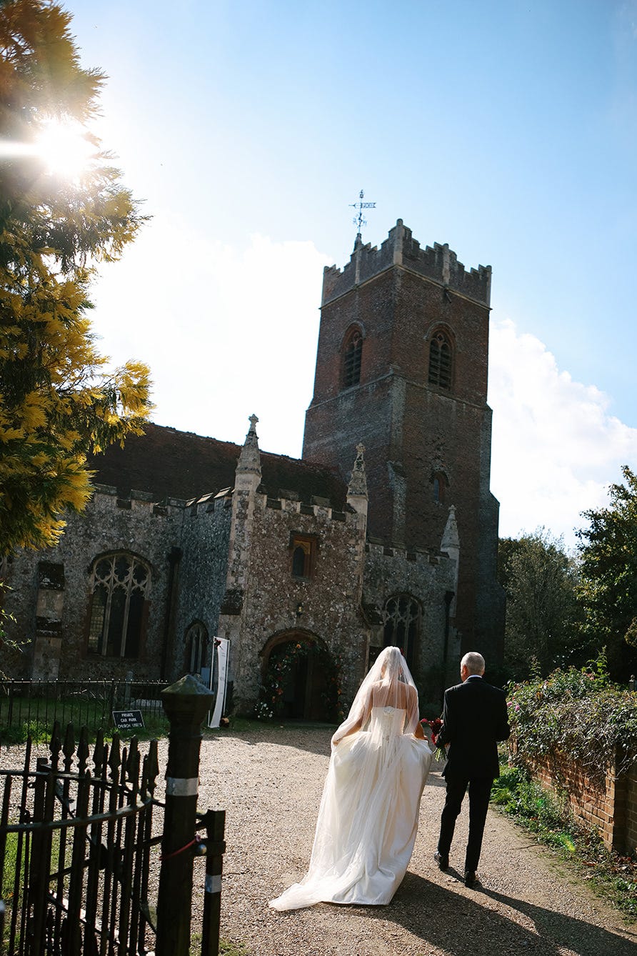 bride amy shaw and her father walking to the church for her wedding ceremony